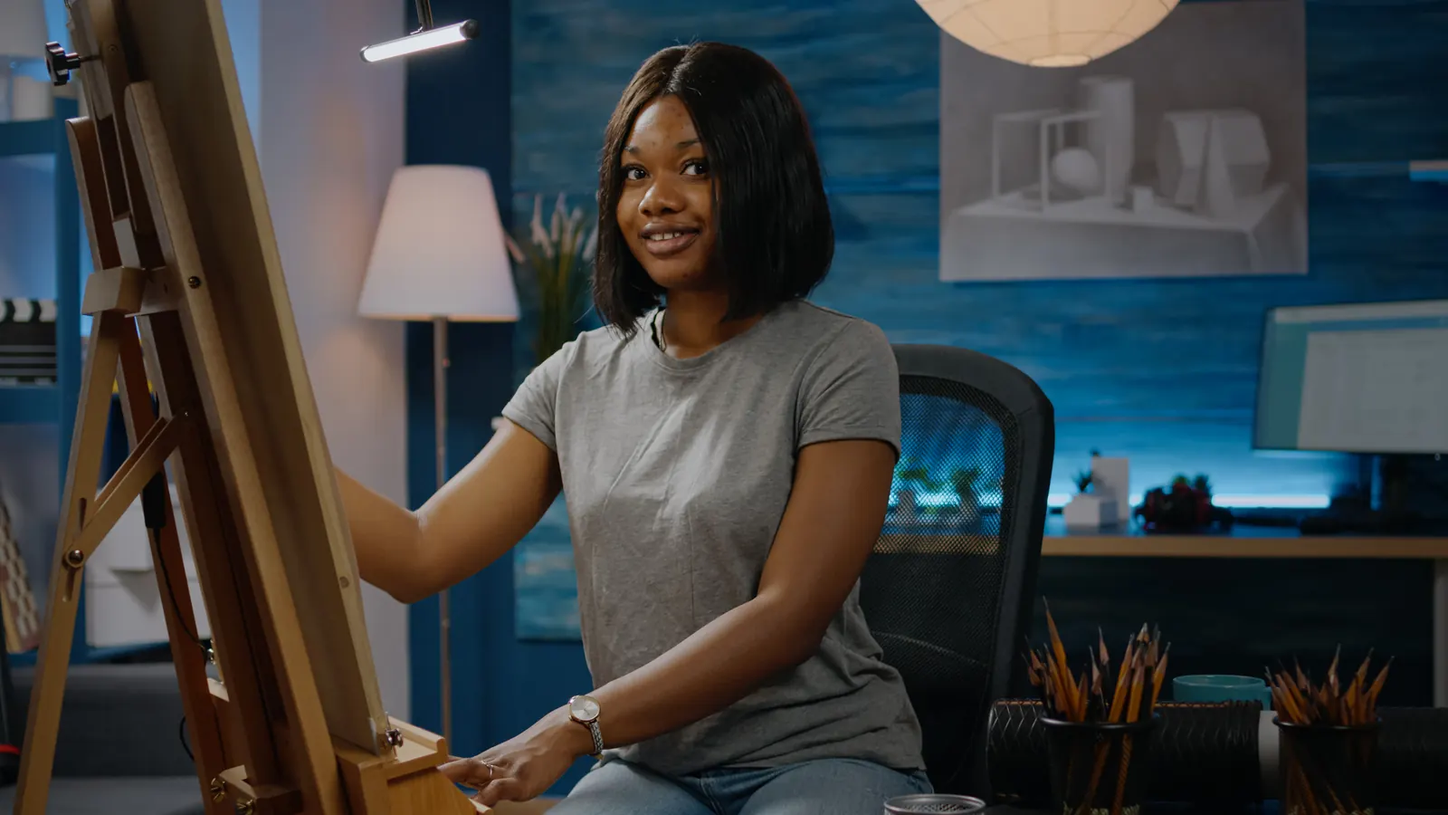 An artist at an easel in her studio